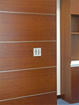 Futronix wall outstation switch panel mounted on a wood paneled wall